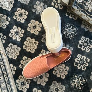 Michael kors pink slip on sneakers.
